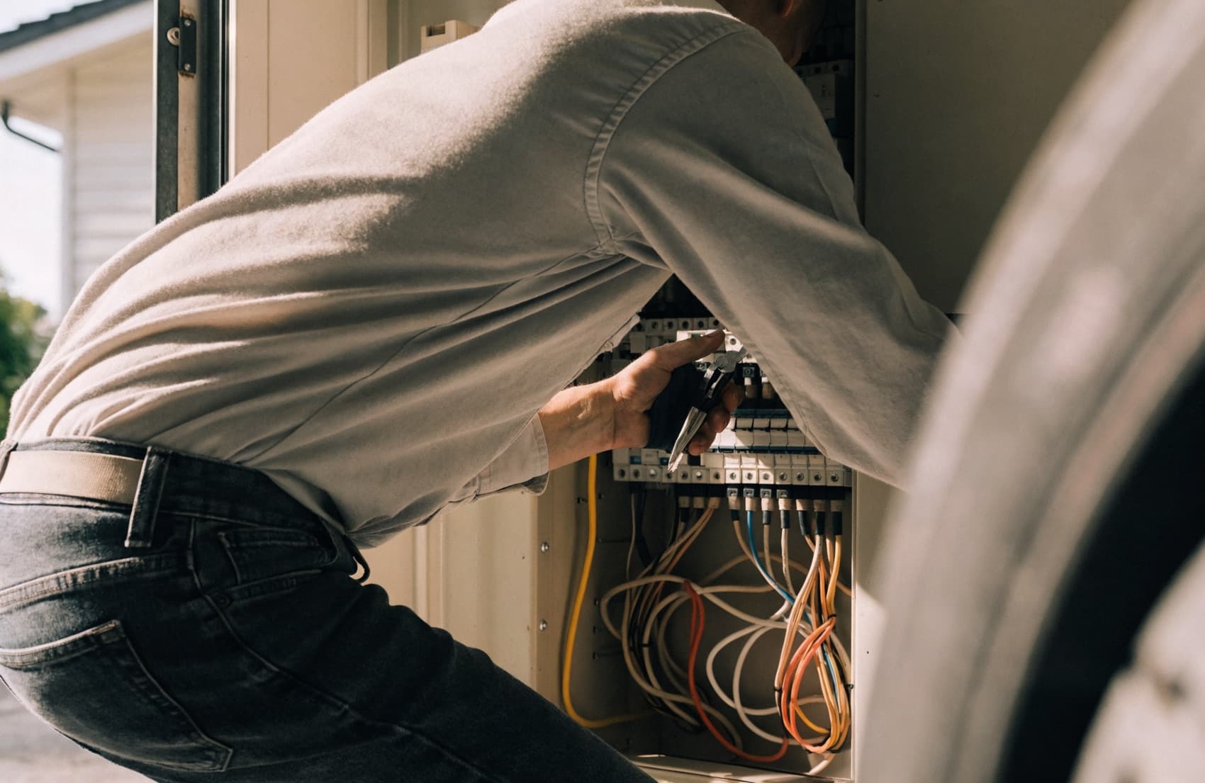 A licensed electrician working on a panel