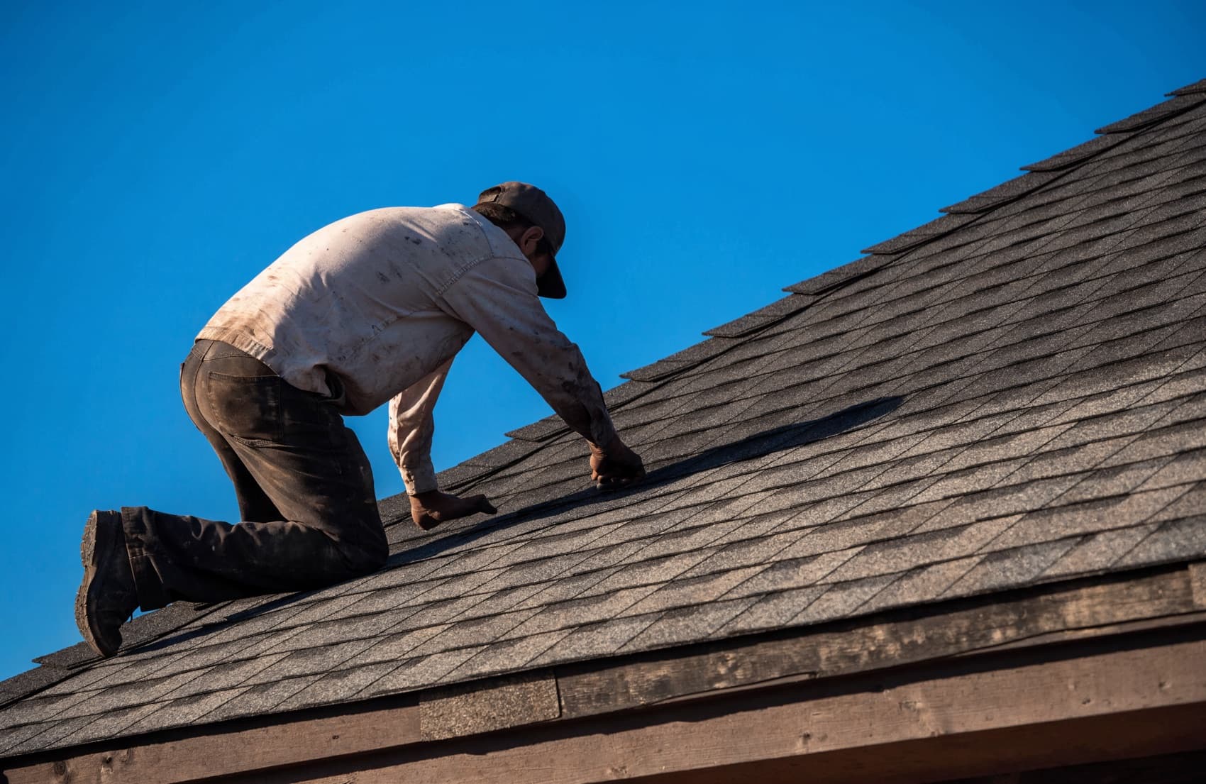 A roofer working on a residential roof